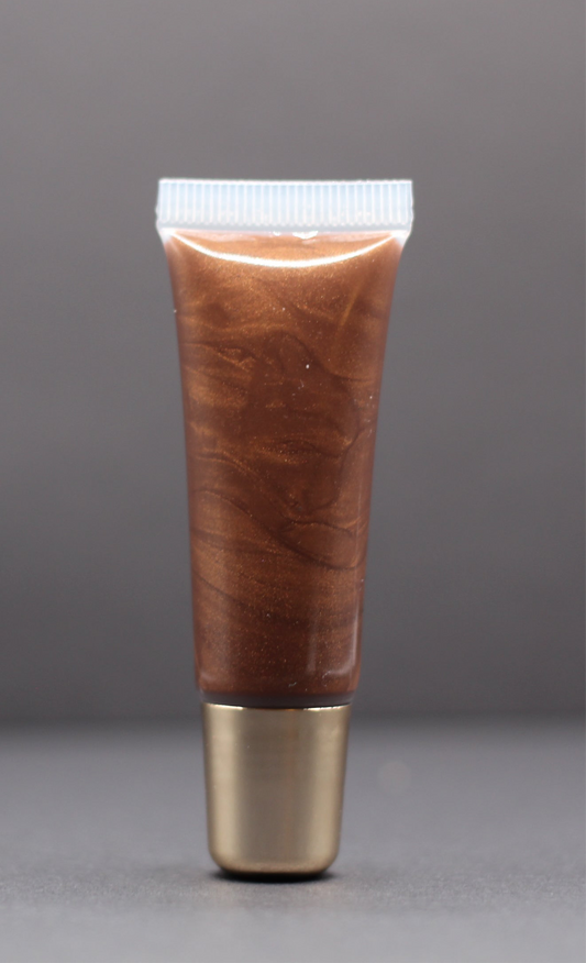 Bronze shimmer vegan lip gloss with a bubble gum scent, nourishing and non-sticky for a warm radiant glow.