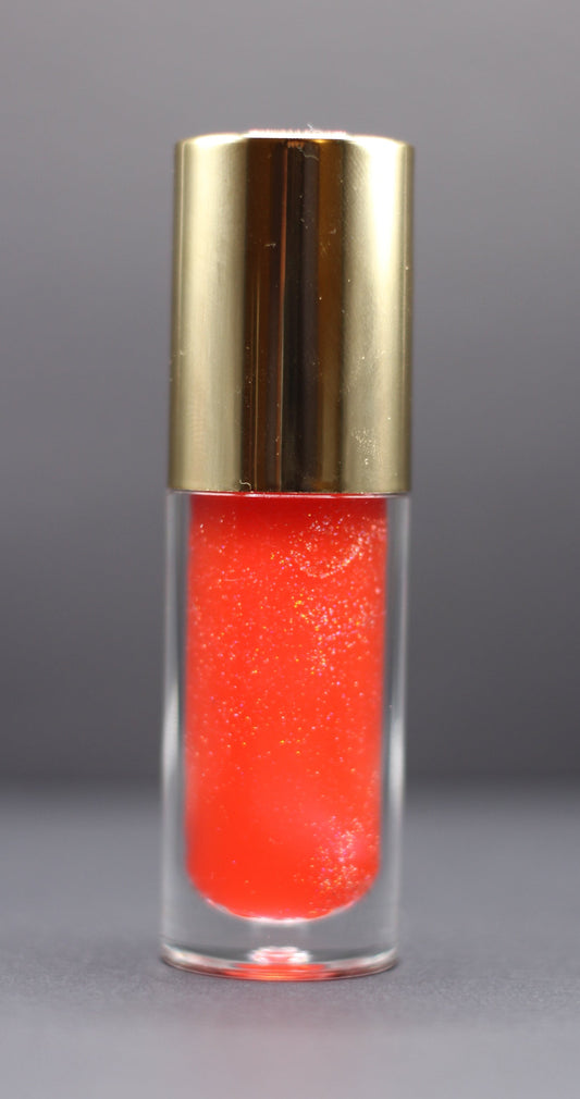 Holographic pink-red vegan lip oil with a fruity strawberry pineapple scent, lightweight with a high-gloss shimmer.